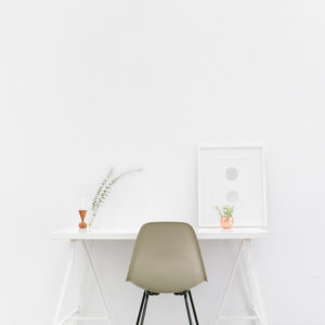 A minimalist desk setup with a fern adds calm to a workspace for effective rto training.