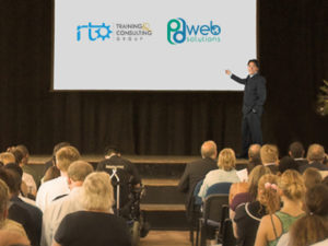 A presenter leads a training session for an audience, showcasing RTO training services.