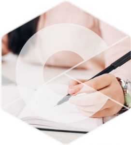 A person signing business paperwork demonstrates the importance of training and assessment.
