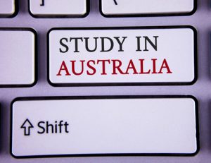 A keyboard key shows 'Study in Australia', reflecting concerns about international student return amid the Covid-19 surge.