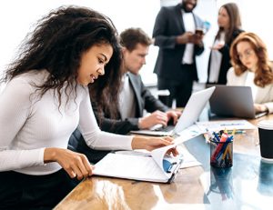 A business team collaborates on course delivery, highlighting effective training and assessment.