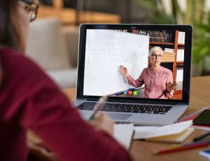 A teacher leads a virtual lesson, demonstrating how to move to online training.