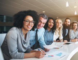 A business team discusses VET in schools during an office meeting.