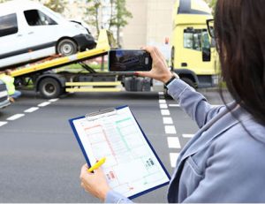 A damage assessment is completed after a car accident, demonstrating video evidence for vet compliance.