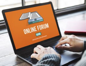 A student uses a laptop to access an online forum for RTO training.