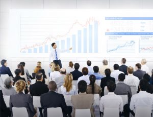 A business presentation shows data visualization relevant to reasonable adjustments.