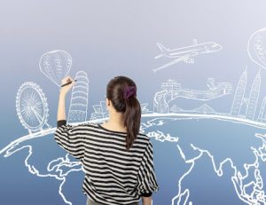 A woman illustrates a world map with landmarks, representing reasonable adjustments for international students in training.