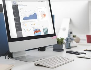 A computer screen displays AVETMISS data visualization, showing how to report data through NCVER tools.