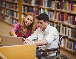 Students collaborate on a laptop, demonstrating accessibility in vocational education and training.