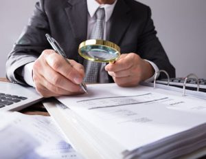 A businessman reviews documents, representing the financial scrutiny during an RTO registration renewal.