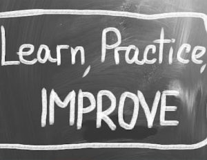 A chalkboard with the phrase 'Learn, Practice, IMPROVE' highlights the importance of continuous improvement in VET.