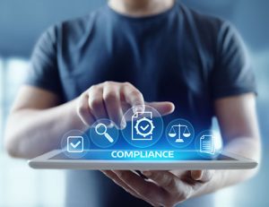 A person uses a digital tablet to review vet compliance data and icons.