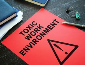 A warning sign depicts a toxic work environment, impacting employee health.