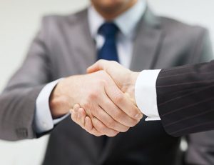 Business people shake hands, representing key appointments in the vet sector.