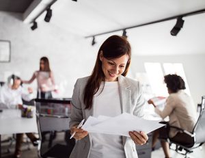 A businesswoman reviews training documents, highlighting effective assessment strategies for RTOs.