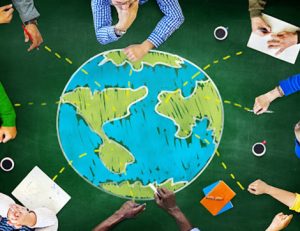 A diverse group collaborates around a world map, highlighting international education in Australia.